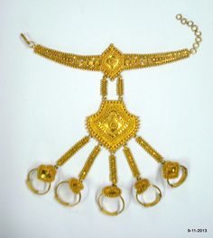 "20K GOLD BRACELET DORSAL HAND ORNAMENT (HATHPHUL; HATH HAKALU; PANCHANGALA), THAT INCLUDES, IN ADDITION TO THE USUAL ELEMENTS, ORNAMENTS FOR THE FINGER ENDS. Great design bracelet with 5 finger rings attached (hathful).Rings are attached with the middle piece by handmade chains. See similar sample in\" Traditional jewelry of India\" by Oppi Untracht. Size of the bracelet - 19.3 cm(7.6\") we can adjust the size. Ring sizes - Free size weight - 51.8 grams Material - 20k yellow gold." Traditional Adjustable Metal Anklets, Adjustable Metal Traditional Anklets, Traditional Gold Adjustable Anklets, Traditional Gold Anklets Adjustable, Traditional Gold Anklets With Adjustable Fit, Gold Anklets With Latkans For Festival, Traditional Gold Anklets For Festivals, Metal Bracelets With Latkans For Festival, Gold Bracelet For Festive Occasions