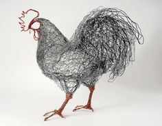 a wire sculpture of a rooster on a white background