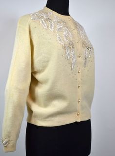 Vintage 1950's Beaded Button down Cardigan Fit For a Queen  Size: M/42 Material: 20% angora, 10% nylon, 70% Lambswool Sweater: White Pearls, clear glass beads, sequins, opalescent, tiny delicate black accent beads, Beading on a creamy pale gold sweater, Fully lined, Full bodice beading, back shoulder blade beading, delicate cuff beading Condition: Has three tiny pin-holes which are marked by the pins in the above photo Winter Formal Embellished Cardigan, Cream Formal Cardigan For Winter, Formal Winter Embellished Cardigan, Vintage Long Sleeve Formal Cardigan, Vintage Cardigan For Evening In Winter, Vintage Winter Cardigan For Evening, Vintage Long Sleeve Cardigan For Evening, Formal Embellished Winter Cardigan, Vintage Evening Cardigan For Winter