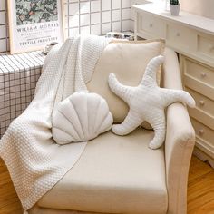 two starfish pillows are sitting on a couch