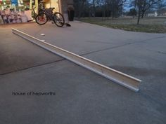 a bicycle is parked in front of a store with its door open and it's leaning against the wall