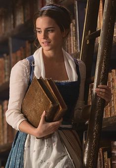 a woman in an old fashioned dress holding books