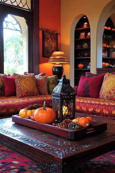 a living room filled with furniture and lots of pillows on top of a coffee table