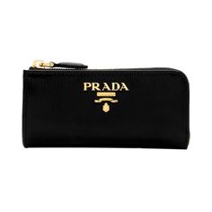 This compact Prada keychain wallet is constructed with black vitello move leather. The zipper fastening opens to a smooth black leather interior with a detachable keychain. The key holder case wallet can fit keys, credit cards, bills, and coins. This functional and stylish piece from Prada is the perfect size to hold your daily essentials!    Model: 1PP026    Black vitello move leather  Gold-tone hardware  Zipper fastening  Prada logo plaque    Detachable keychain, approx. 1.25 inches  Smooth bl Luxury Black Coin Purse With Interior Key Chain Holder, Black Travel Coin Purse With Key Clip, Black Coin Purse With Key Clip For Travel, Modern Black Wallet With Key Clip, Prada Keychain, Prada Logo, Keychain Wallet, Key Case, Zip Pouch