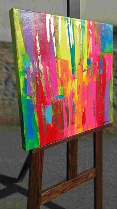 an easel is painted with bright colors