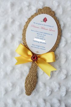 a wedding card with a yellow ribbon on it and a gold frame around the edge