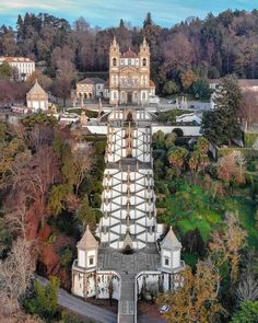 an aerial view of a church in the middle of a forest with many trees around it