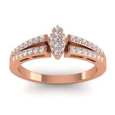 a rose gold ring with white diamonds on the sides and an arrow shaped design in the middle