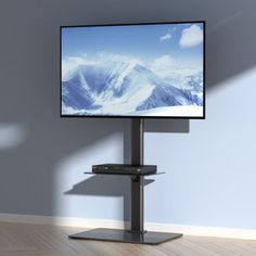 a flat screen tv sitting on top of a metal stand in front of a wall