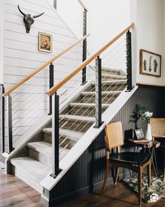 a room with a chair, table and stairs