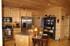 a kitchen with wood paneling and stainless steel appliances