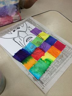 a child's drawing on paper with colored squares