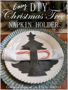 an easy diy christmas tree napkin holder on a white plate with candy canes