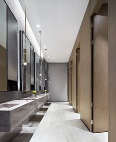 an empty bathroom with multiple sinks and mirrors