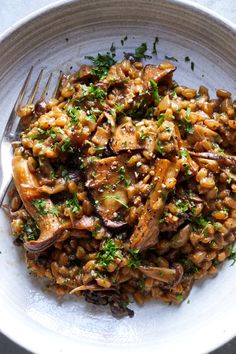 a white bowl filled with rice and mushrooms