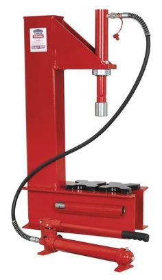 a red hydraulic jacking machine with a hose connected to it's head and arm