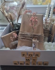 a box filled with lots of different types of items and flowers on top of it