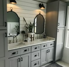 a bathroom with double sinks and two mirrors on the wall next to eachother