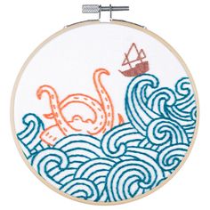 an embroidery pattern with a boat in the ocean and waves on it's side