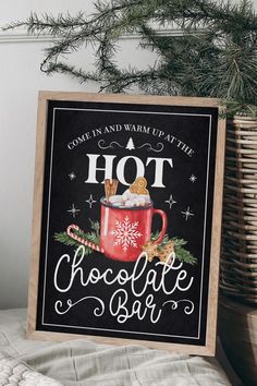 a sign that says hot chocolate bar next to a potted christmas tree and basket