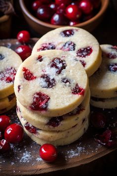 cranberry shortbreads with powdered sugar and fresh cherries in the background