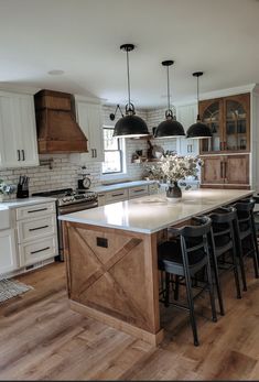 a large kitchen with an island in the middle