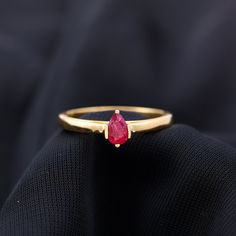 Product Details Begin your path of devotion and unity with the Ruby Promise Ring. Featuring a captivating pear-shaped ruby at its heart, set elegantly as a solitaire on a meticulously crafted metal shank. Product Information SKU SHP-RINGS0821232298 Width 5 mm Height 7 mm Weight 2.64 gm (Approximate) RUBY INFORMATION No.of Stones 1 Pieces Total Weight 0.55 Carat (Approximate) Dimension(approx) Pear-4X6 mm-1 Pcs Color Red Cut Brilliant Shape Pear Setting Type Bar-Setting Quality Grade AAA View More Product Parent Collection Handle engagement-ring Ruby Promise Ring, Pave Diamond Wedding Bands, Ruby Wedding Rings, Ruby Set, Bar Setting, Pear Shaped Ring, Minimal Ring, Pear Ring, 18k Yellow Gold Ring