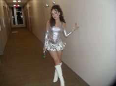 a woman dressed in silver posing for the camera