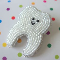 "Cutest tooth brooch pin for the dentist in your life! This little fellow is hand-beaded in pearly white beads, with a subtle glass crystal \"sparkle\" in his upper right corner and edged in silver beads for a little extra bling. He's backed with soft suede, with a round brooch pin attached. Approx Size: 2.25\" tall x 1.5\" wide (please note that sizing can vary slightly due to handmade nature of brooch) He could make the perfect unique gift for someone who works in the dental field, or a fun br Ariel Wedding, Gift For Dentist, Cute Tooth, Dental School, Dentist Office, Gifts For Dentist, Ear Ring, Beaded Brooch, Sterling Silver Necklace Pendants