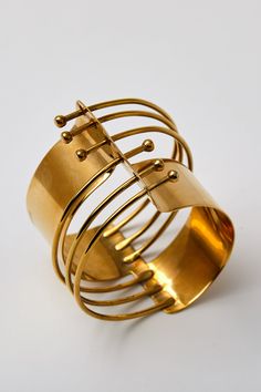 Turn heads with the Brass Modern Wired Bracelet Armlet Arm Cuff—where bold design meets timeless elegance. STATEMENT DESIGN: Unique and eye-catching, perfect for enhancing any outfit. QUALITY CRAFTSMANSHIP: High-quality brass ensures durability and lasting style. Material Composition: Solid Brass Size: 3.5" diameter Care Instructions: Bisjoux products made of solid raw brass, or silver plated brass will patina naturally over time. Dulled by age, and naturally buffed from regular touch. Your raw Adjustable Contemporary Cuff Bracelet, Adjustable Contemporary Bangle Bracelet, Modernist Metal Bangle For Formal Occasions, Adjustable Modernist Bangle Bracelet, Adjustable Modernist Bangle For Formal Occasions, Formal Modernist Metal Bangle, Adjustable Metal Contemporary Cuff Bracelet, Modernist Metal Cuff Bangle, Contemporary Adjustable Metal Cuff Bracelet