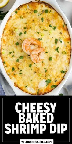 cheesy baked shrimp dip in a white casserole dish with lemons and parsley on the side