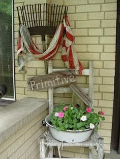 a potted plant sitting on top of a wooden chair next to a brick wall