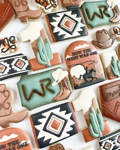 many decorated cookies are arranged on a white surface with the words, how the west was one