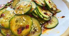 cucumbers with sesame seeds and sauce on a plate