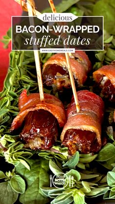 bacon wrapped stuffed dates with toothpicks in them on a platter surrounded by greens