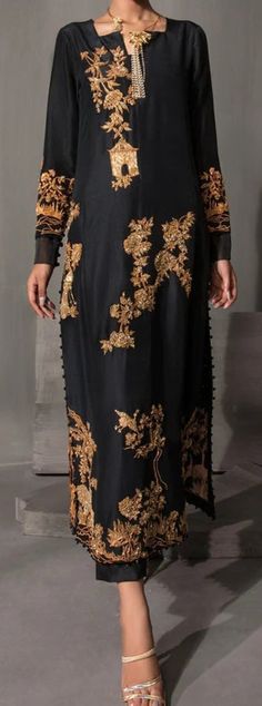 Product Description:  Hand embellishment and thread work. Color: Black Includes:  Shirt, Pants. Fabric Detail:  Shirt: Raw silk Pants: Raw silk Note: Shirt length may vary as per outfit design. Elegant Floor-length Salwar Kameez With Gold Embroidery, Elegant Party Salwar Kameez With Gold Embroidery, Elegant Salwar Kameez With Gold Embroidery For Party, Black Embroidered Salwar Kameez For Party, Black Sets With Gold Embroidery For Party, Black Party Sets With Gold Embroidery, Elegant Embellished Salwar Kameez For Evening, Black Palazzo Set With Dabka Work For Party, Elegant Pants For Eid Party