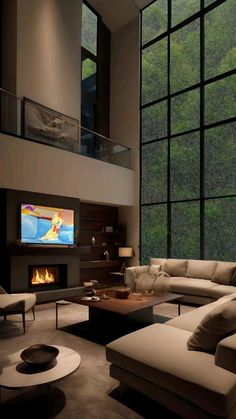 a living room filled with lots of furniture and a flat screen tv mounted to the wall