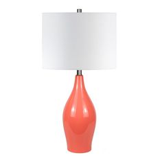 an orange lamp with a white shade on it