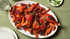 a white plate topped with chicken wings and carrots