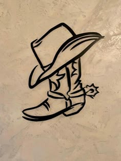 a drawing of a cowboy with a hat and star on the side of a wall