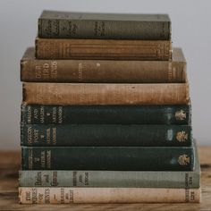 a stack of books sitting on top of a wooden table