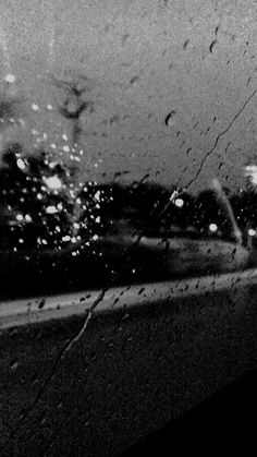 black and white photograph of rain on the windshield