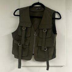 Small Sized Green Cargo Vest From Shein. Four Pockets On The Front. Great Material And Brand New Condition! Packaged In The Original Bag It Came With. Fittwd Vest, Green Long Sleeve White Vest, Green Hooded Gilet, Heavy Duty Vest, Green Vest Long, Z Supply Vest, Womens Streetwear Vest, Cheap Green Crossbody Satchel, Wool Vest Jacket