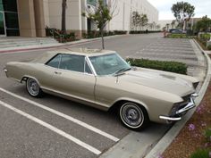 an old car is parked in the parking lot