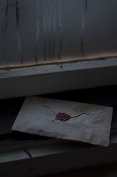 a piece of paper sitting on top of a window sill