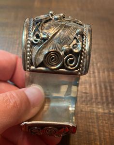 "An amazing example of Native American Navajo Jewelry by artist Allen Chee. A very detailed bear motif cuff bracelet made in sterling silver with turquoise accents. The high relief bracelet measures 1 3/4\"- 1 1/8\" with an inside opening of 1 1/8\"-2 9/16\". Signed by artist Allen Chee. Very good condition. I have not polished or cleaned. Circa 1970's" Artisan Silver Concho Cuff Bracelet, Silver Hand-tooled Artisan Cuff Bracelet, Silver Artisan Hand-tooled Cuff Bracelet, Vintage Silver Hand-tooled Cuff Bracelet, Artisan Silver Cuff Bracelet Hand Tooled, Vintage Silver Hand Tooled Cuff Bracelet, Artisan Hand-tooled Silver Cuff Bracelet, Bear Bracelet, Turquoise Accents