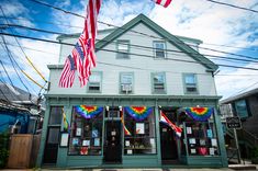 an american flag is hanging in front of a building with many flags on the outside