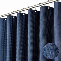 blue curtains hanging on the side of a metal curtain rod in front of a white wall