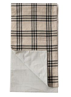 a blanket with a white and black plaid pattern