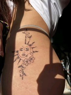 a woman with a sun tattoo on her stomach